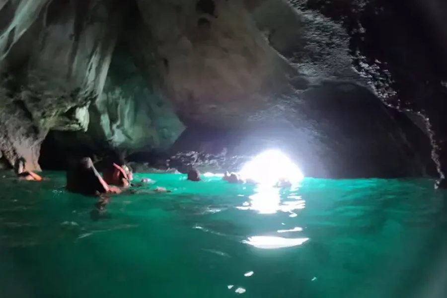 Drone aerial view Koh Kradan turquoise sea coral reef longtail boat cruising top view