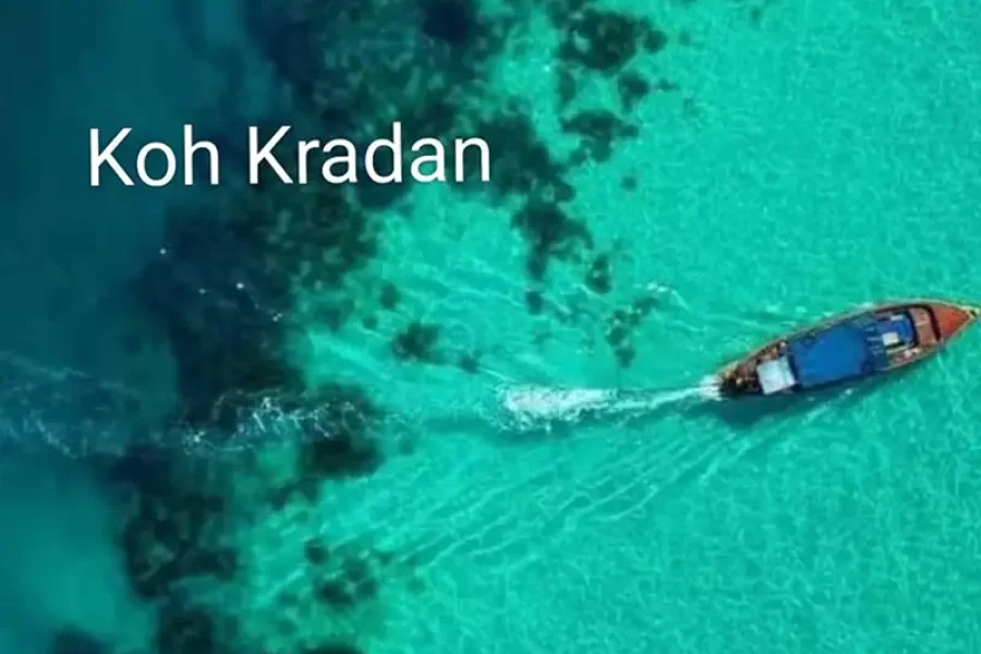 Tourists swimming inside Emerald Cave Koh Mook emerald green water dark cave light at exit